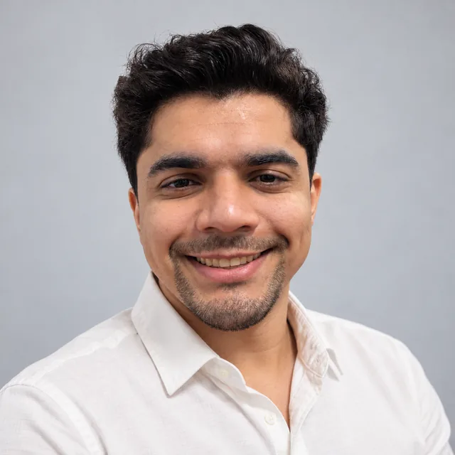 Retrato de Lucas Monteiro, de camisa branca, sorrindo.